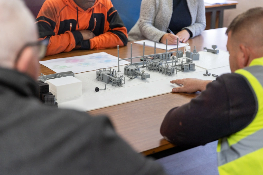 Heyside Group team meeting with 3D printed products in the centre of the table