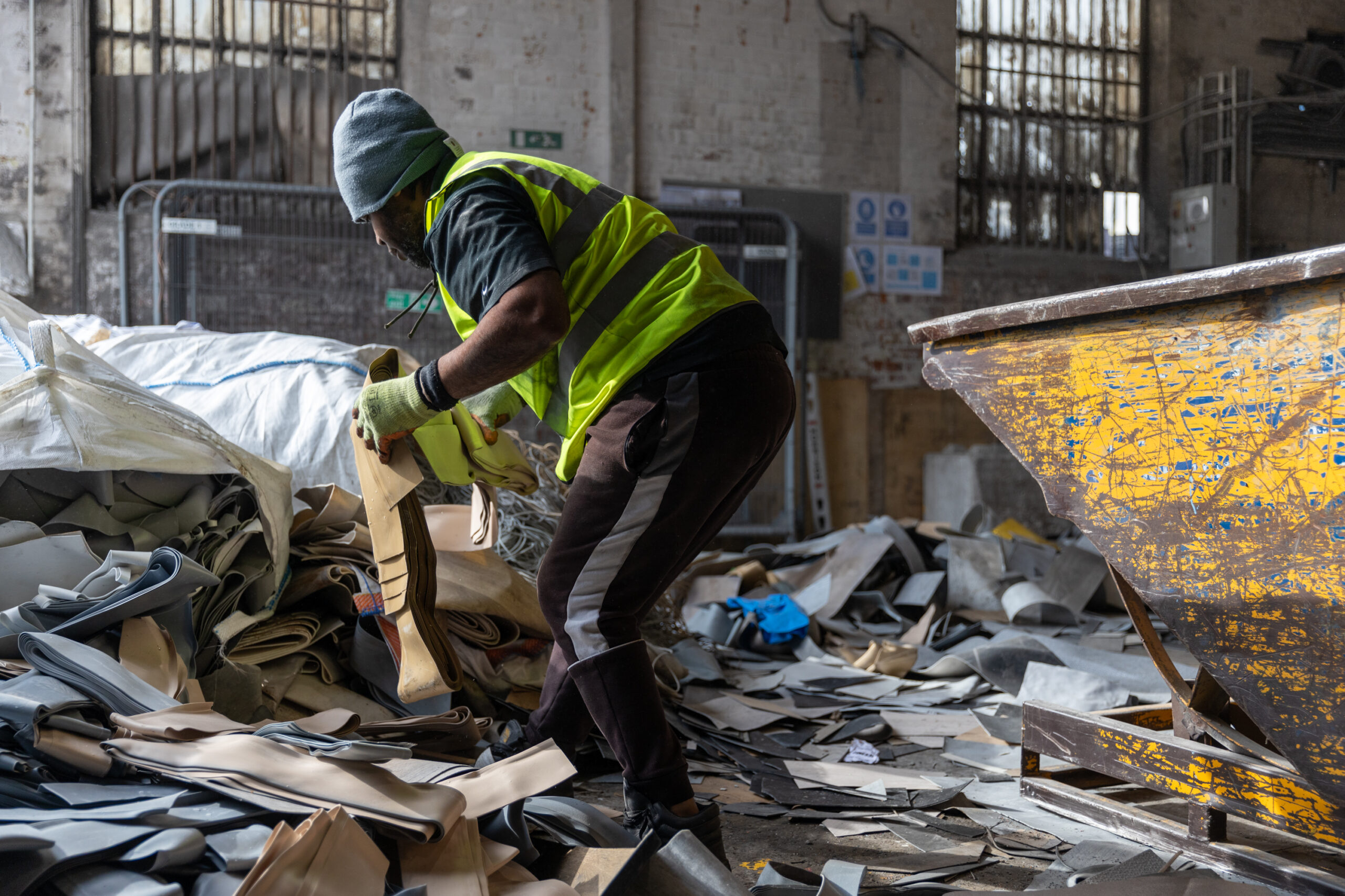 Heyside Group team member sorting through recycled plastic