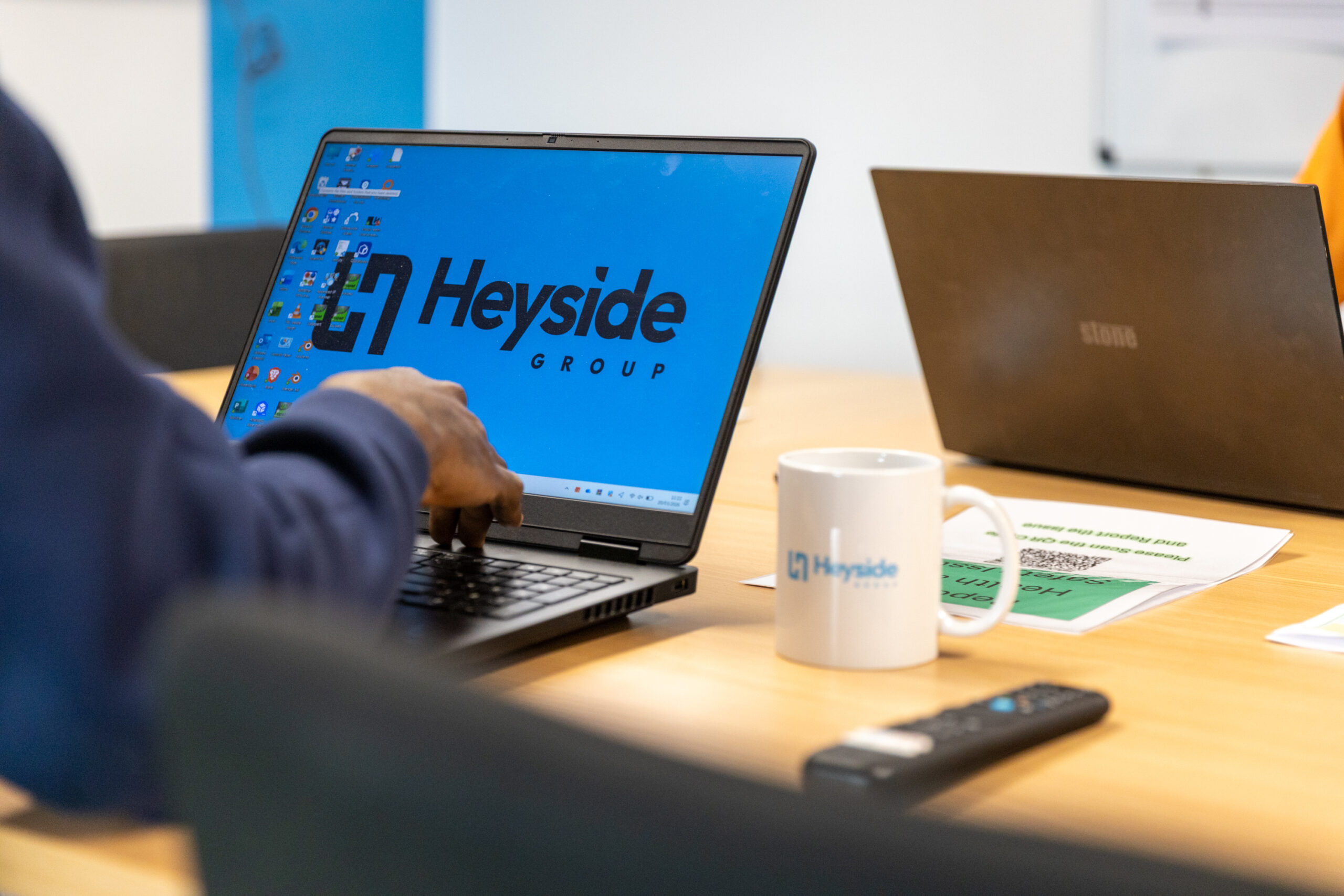 Laptop displaying Heyside Group logo